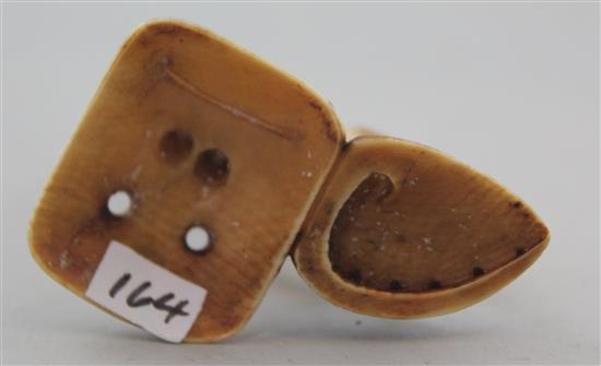 A Japanese ivory netsuke of Ashinaga holding the nose of a Tengu mask, Edo period, 6.9cm